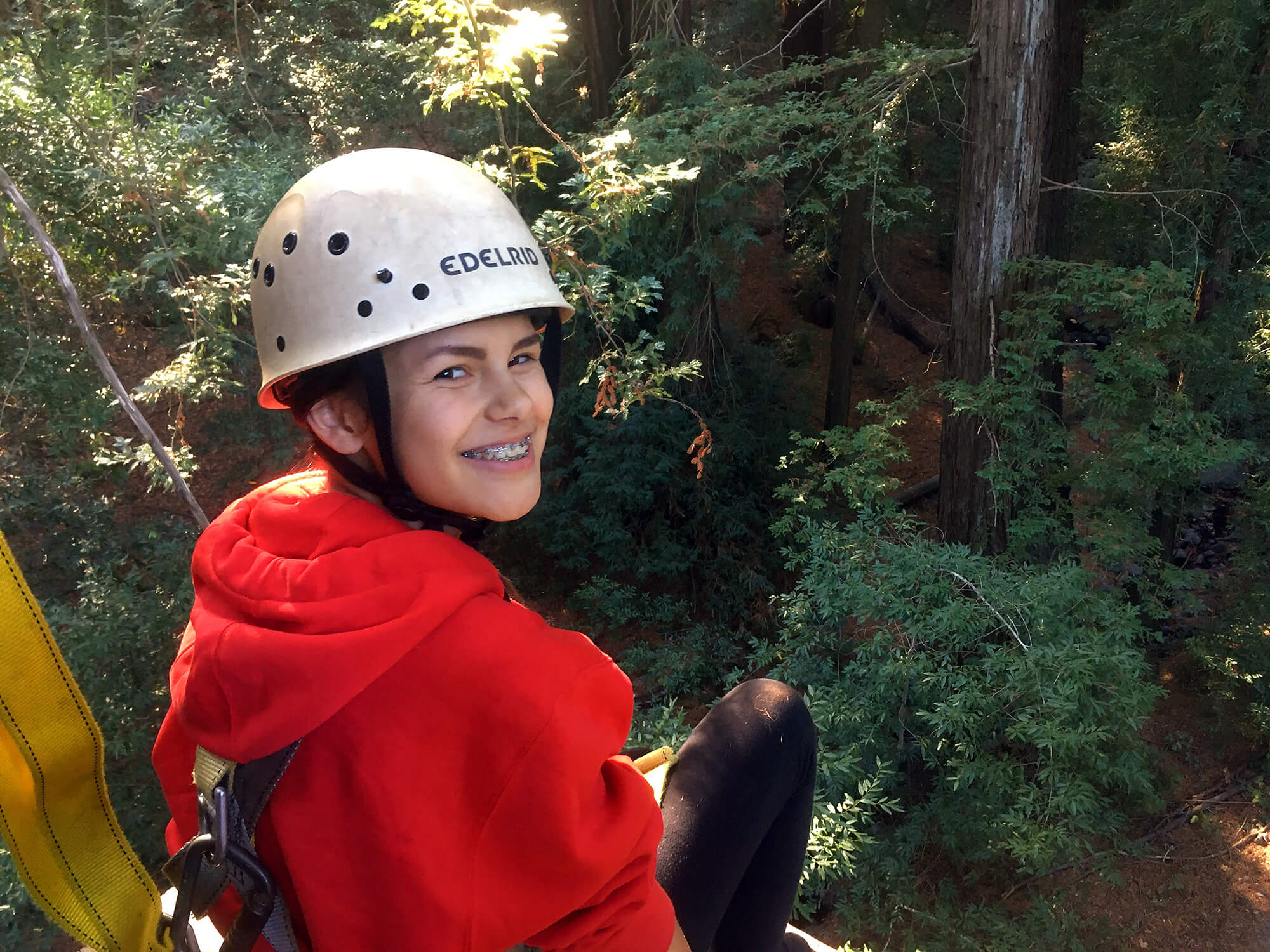 A Quest Forward Academy Santa Rosa student at the top of a ropes course.