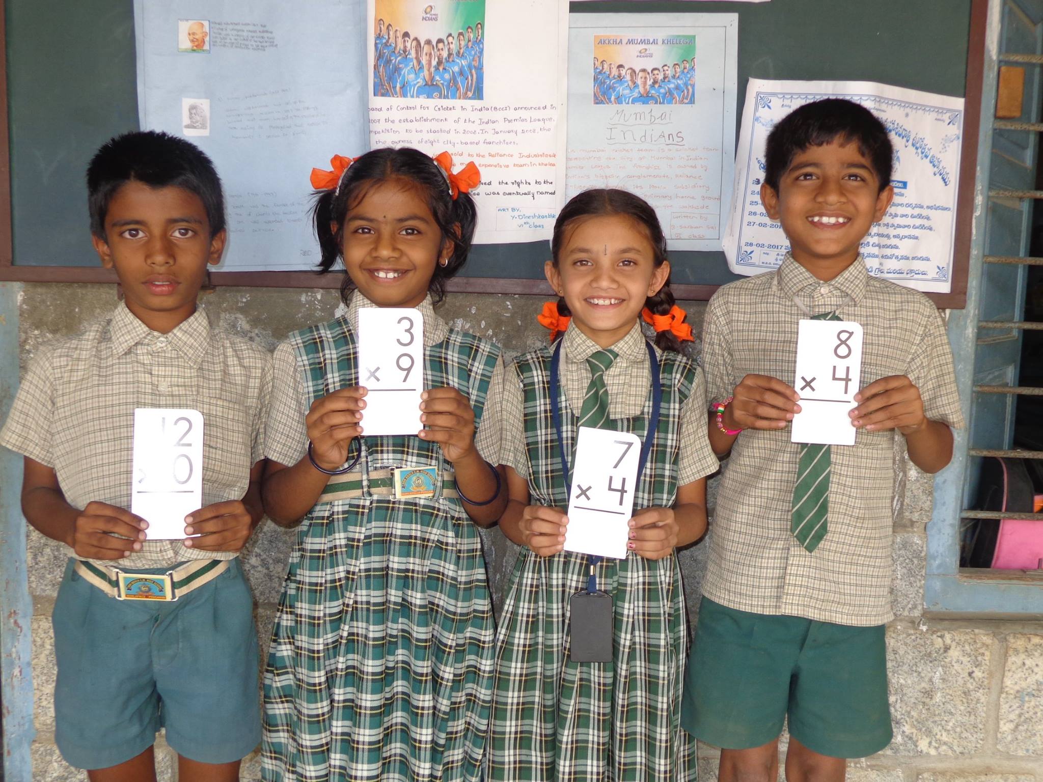 Primary Program students in India hold math materials provided by Opportunity Education, founded by Joe Ricketts
