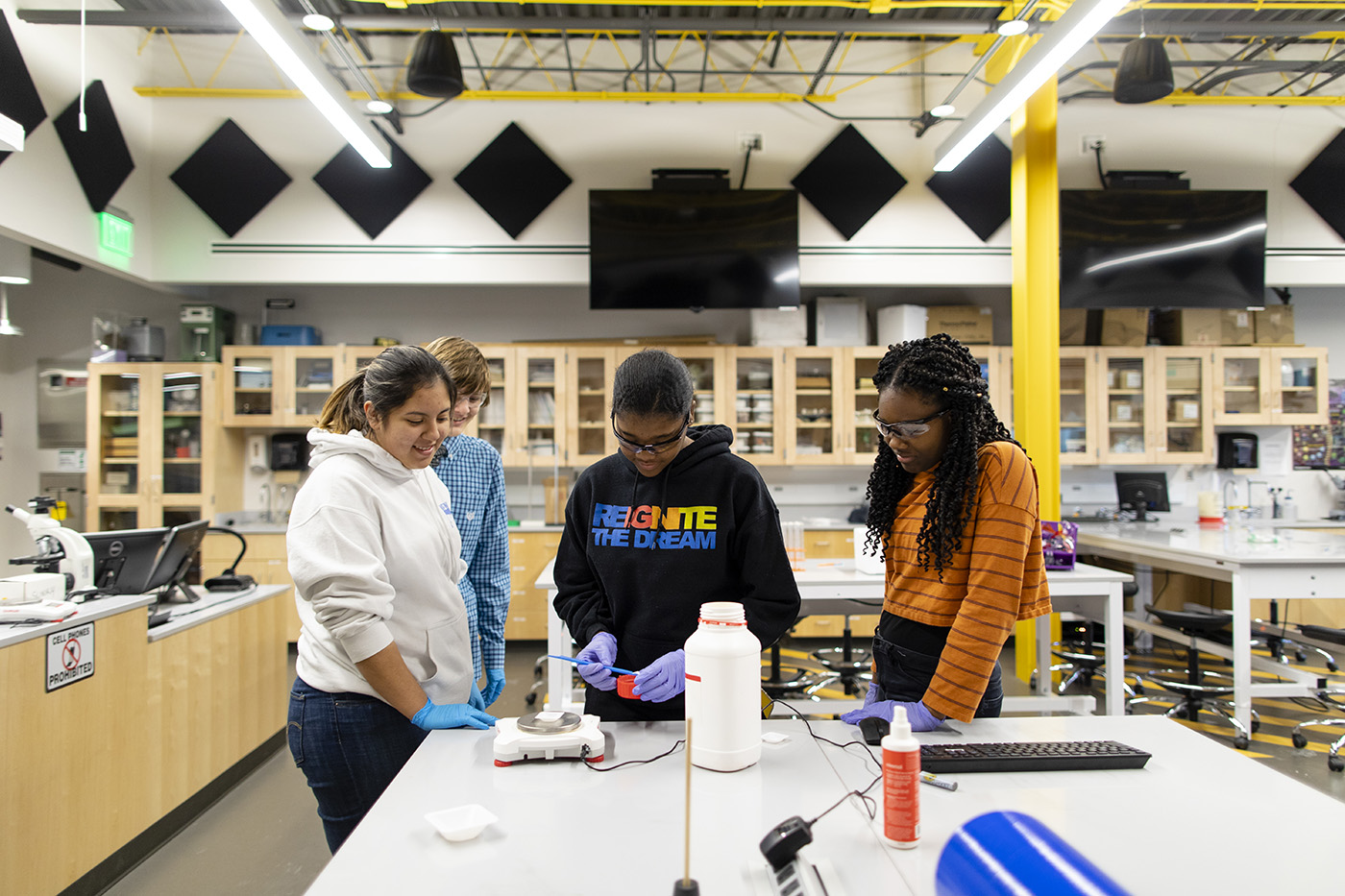 Students at Quest Forward Academy Omaha collaborate on a project in the Bellevue University science lab.