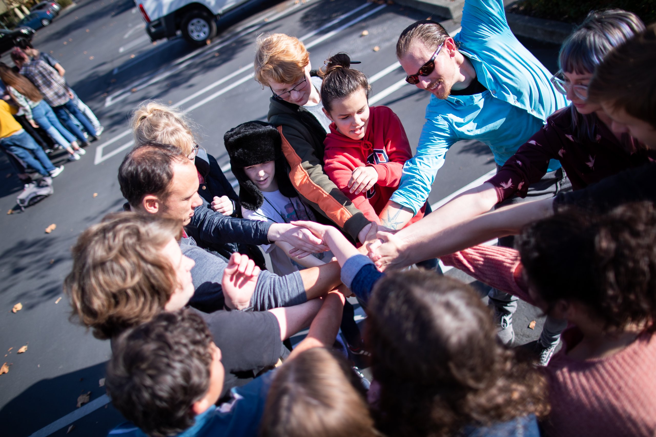 Nils Palsson and fellow Quest Forward Academy mentors and students perform a team-building exercise outside.