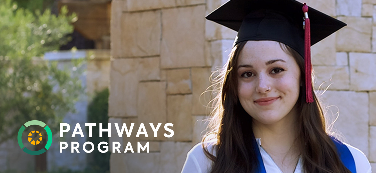A college graduate in cap and gown smiles alongside the Pathways Program logo